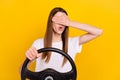 Photo of young scared young amazed woman hold hand cover eyes steering wheel isolated on yellow color background Royalty Free Stock Photo