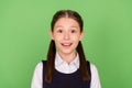 Photo of young school girl happy positive smile amazed surprised news  over green color background Royalty Free Stock Photo