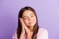 Photo of young schoolgirl happy smile enjoy rest relax sleep dream dreamy isolated over purple color background