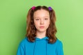 Photo of young serious teenager girl calm peaceful face wear casual clothes isolated on green color background