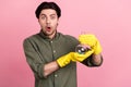 Photo of young shocked amazed excited man hold hand chemical wear gloves isolated on pink color background