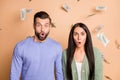 Photo of young shocked amazed surprised couple wife husband win lot of money isolated on beige color background Royalty Free Stock Photo