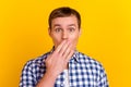 Photo of young shocked amazed surprised man cover mouth with hands oops guilty isolated on bright color background
