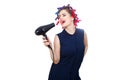 photo of young singing woman in curler with hairdryer