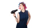 photo of young singing woman in curler with hairdryer