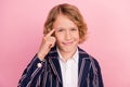 Photo of young small boy finger touch head think memory accuse tease stupid isolated over pink color background