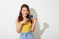 Photo of young smiling asian woman holding card