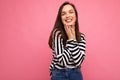 Photo of young smiling positive happy pretty brunette woman with sincere emotions wearing casual striped pullover Royalty Free Stock Photo