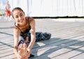 Photo of young smiling woman make yoga exercises on a wooden pier. Royalty Free Stock Photo