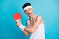 Photo of young sportsman angry mad scream hold tennis racquet game player isolated over blue color background Royalty Free Stock Photo