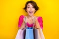 Photo of young surprised girl guess inside her shopping bags sale advert gifts for birthday party new clothes isolated Royalty Free Stock Photo