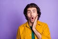 Photo of young surprised worried shocked man male guy hear unbelievable news information isolated on violet color