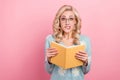 Photo of young teacher blonde wavy hair girl hold her diary reading bad stories classmates bite lips isolated on pink