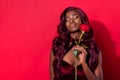 Photo of young tender black girl hold rose flower valentine day gift dream enjoy over red color background