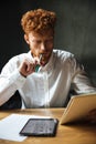 Photo of young thinking readhead bearded man in white shirt