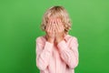 Photo of young unhappy sad upset boy cover hands close face bad mood isolated on shine green color background Royalty Free Stock Photo