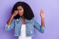 Photo of young unhappy upset african woman cover close nose bad smell show no sign isolated on purple color background