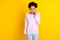 Photo of young unhappy upset afro american sad woman hold hands phone talk isolated on yellow color background