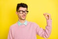 Photo of young unhappy upset uncertain doubtful man in glasses speak with talking hand isolated on yellow color