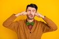 Photo of young unsatisfied man arms fists wipe tears on face look camera isolated on yellow color background