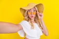 Photo of young woman amazed shocked information make selfie hand touch glasses isolated over yellow color background