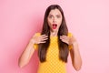 Photo of young woman amazed shocked surprised unhappy upset news fake novelty isolated over pink color background