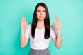 Photo of young woman angry negative show hands no stop reject denial sign isolated over teal color background