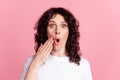 Photo of young woman arm near mouth amazed shocked omg fake gossip isolated over pink color background Royalty Free Stock Photo