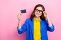 Photo of young woman brunette hair wear stylish formal outfit new specs hold plastic ebank card dream look mockup Royalty Free Stock Photo