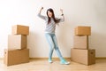 Photo of young woman among cardboard boxes Royalty Free Stock Photo