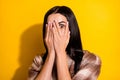 Photo of young woman cover face hands hide look afraid scared horrified isolated over yellow color background