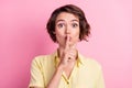 Photo of young woman cover lips finger shh confidential shut up keep secret isolated over pink color background Royalty Free Stock Photo