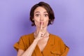 Photo of young woman cover lips finger shh keep secret confidential over violet color background