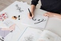 Photo of young woman hands writing beautiful notes on paper with open book on desk isolated Royalty Free Stock Photo