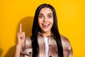 Photo of young woman happy positive smile point finger excited think excellent idea solution isolated over yellow color