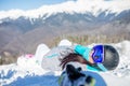 Photo of young woman in helmet and with snowboard lying on mountain slope Royalty Free Stock Photo