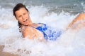 Photo a young woman  lying on the beach sea, among waves and foam Royalty Free Stock Photo