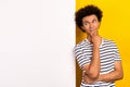 Photo of youngster guy dude lean big white poster interesting shopping offer wear striped t-shirt isolated yellow color Royalty Free Stock Photo