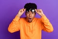 Photo of youong shocked dark skin man wear sunglass amazed sale news isolated on purple color background Royalty Free Stock Photo