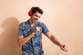 Photo of youth guy listen apple music in new application with free subscription he dancing like crazy isolated on beige Royalty Free Stock Photo
