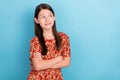 Photo of youth lovely girl curious look empty space folded hands isolated over blue color background