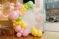 photo zone with pink, yellow, green balloons for children's holiday