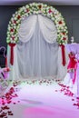 Photo zone for the wedding ceremony of the newlyweds. White path and arch decorated with flowers.