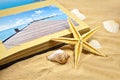 Photoalbum with souvenirs and shells with sand