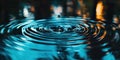 Photobanner, a drop of water breaks the water surface with concentric ripples on a dark blue water surface. Water Royalty Free Stock Photo
