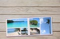 Photobook Album on Deck Table with Travel Photos