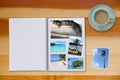 Photobook Album with Travel Photo on Wooden Floor Table with Coffee or Tea in Cup