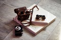 Photobook in bright leather, retro binoculars and old camera. Creative Royalty Free Stock Photo