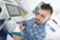 photocopier technician reading instruction manual Royalty Free Stock Photo