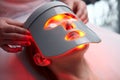 Photodynamic face mask therapy for female in beauty salon